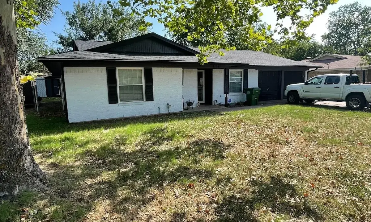 Professional roofing crew working on a residential roof in Rochester